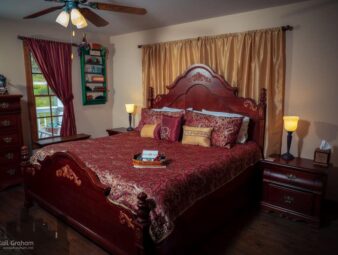 King sized bed with red and gold bedspread