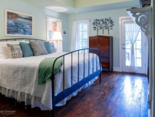 Cypress Cove room, irom bed with white comfortor, very restful colors