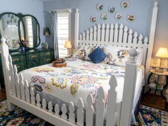 White Picket bedframe with flowered bedspread